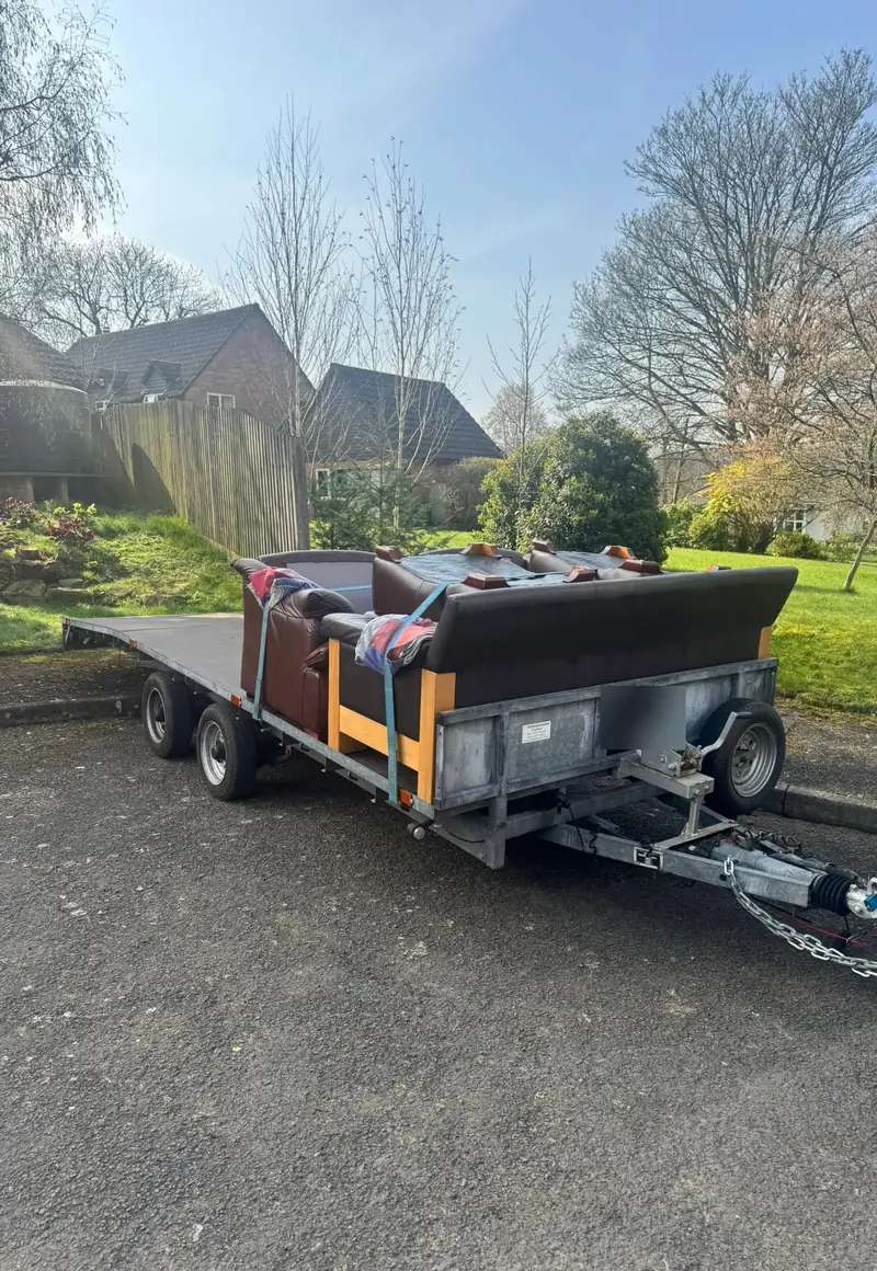 Furniture strapped onto a flatbed trailer for delivery