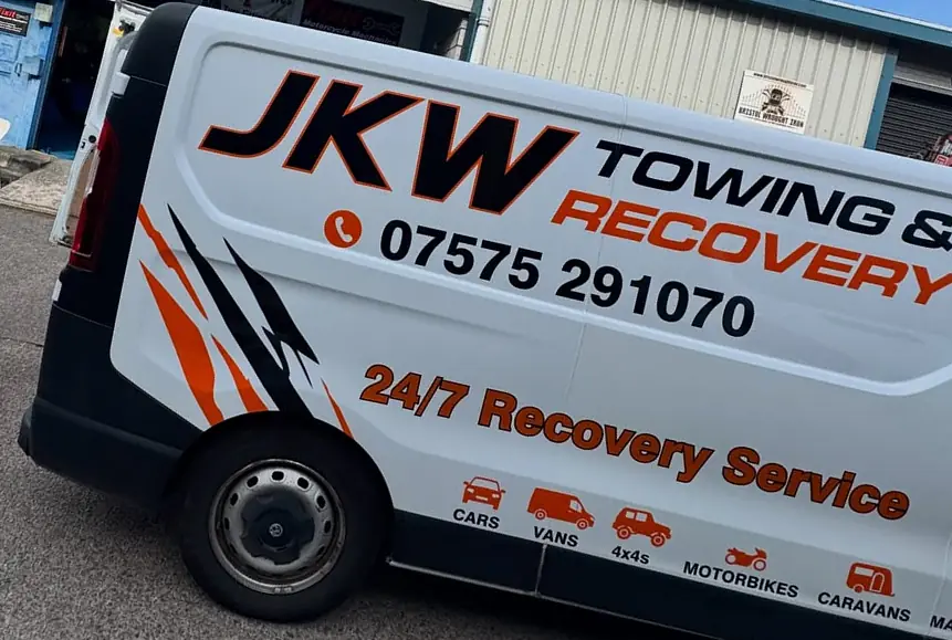 Side of the JKW Towing & Recovery van showing the 07575 291070 phone number